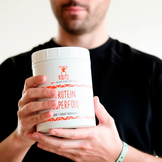 Man holding Rootz protein container.